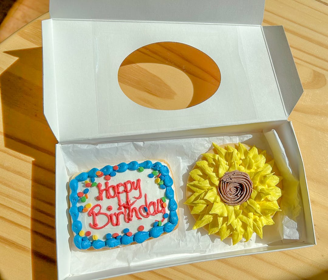 A picture of Birthday decorated cookies in a box